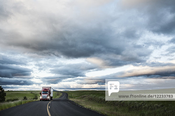 truck on a highway through the grasslands area of eastern Washington  USA.
