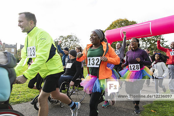 Enthusiastic runners running at charity run in park
