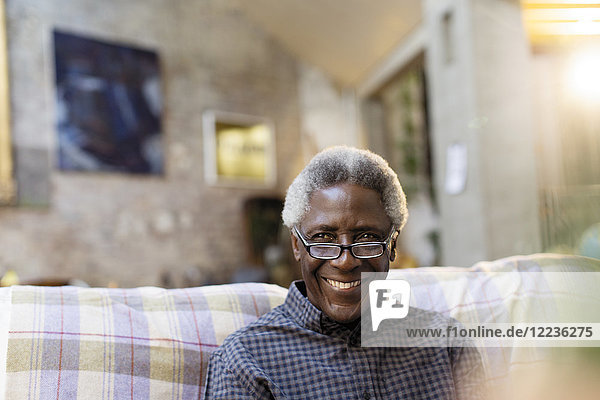 Portrait smiling  confident senior man on sofa
