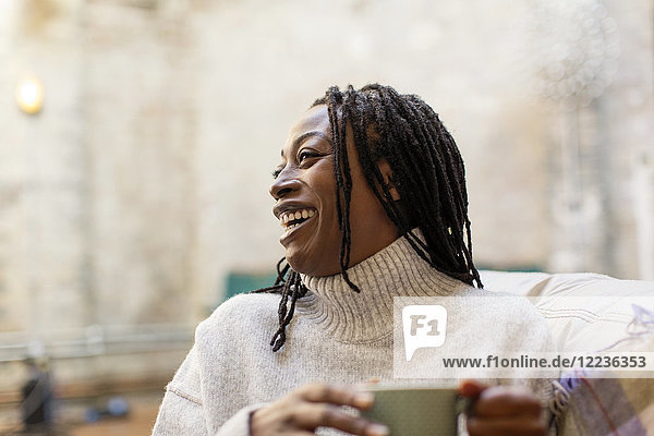 Laughing  happy woman drinking coffee