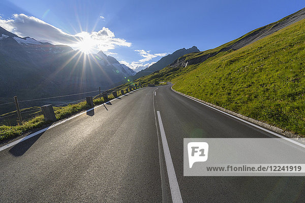 Mountain road with sun at Grossglockner High Alpine Road in the Hohe Tauern National Park  Carinthia  Austria