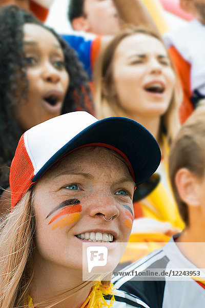 Deutsches Fußball-Fan-Beobachtungsspiel mit gemaltem Gesicht als Unterstützung