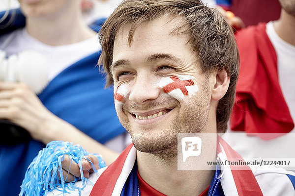 Britischer Fußballfan lächelt fröhlich beim Spiel  Porträt