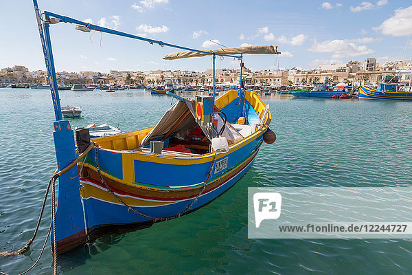 Traditional brightly painted fishing boat in the harbour at Marsaxlokk  Malta  Mediterranean  Europe