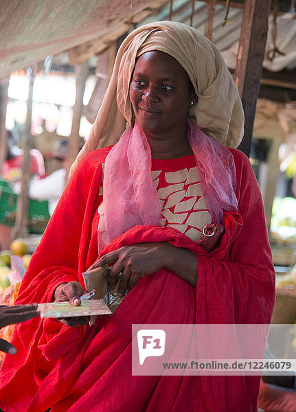 A colourfully dressed woman in the market in Stone Town Zanzibar Tanzania East Africa Africa