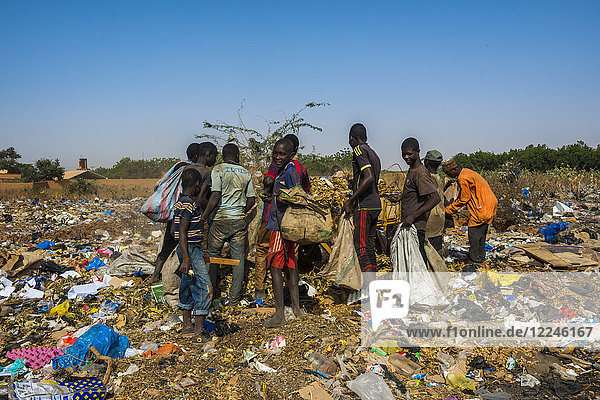 Local boys looking for valuables in the public rubbish dump  Niamey  Niger  Africa