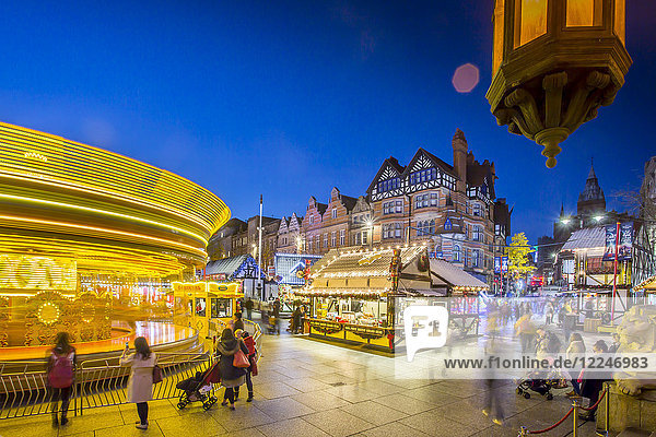 Christmas Market  Carousel and lamp on Old Market Square at dusk  Nottingham  Nottinghamshire  England  United Kingdom  Europe