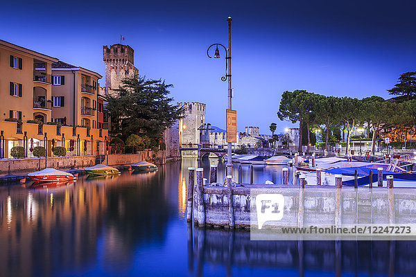 View of Scaliger Castle and boats in harbour at dusk  Sirmione  Lake Garda  Lombardy  Italian Lakes  Italy  Europe