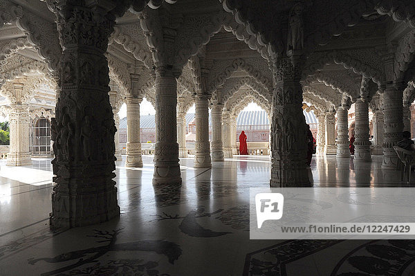 Woman in red sari in the marble pillared hall of Shri Swaminarayan temple  built after the 2001 earthquake  Bhuj  Gujarat  India  Asia