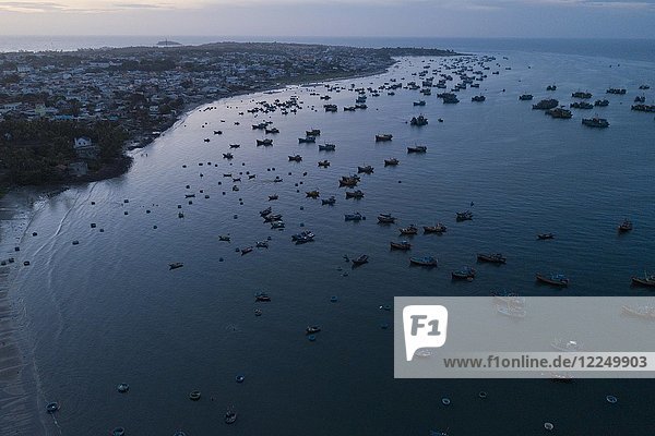 Hundreds of fishing boats return to the beach at dawn  aerial view  sea at Mui Ne  Vietnam  Asia