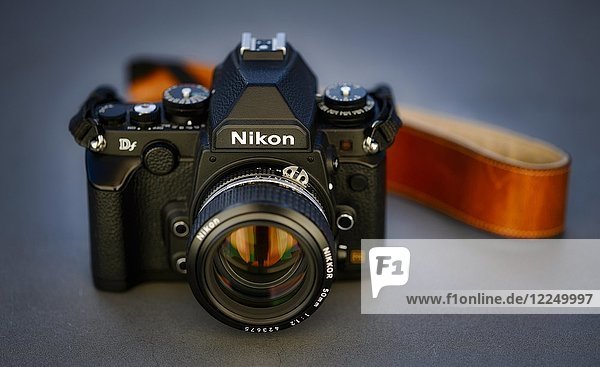 DSLR Nikon Df with Nikkor AI-S 50mm 1.2 in retro style  studio shot