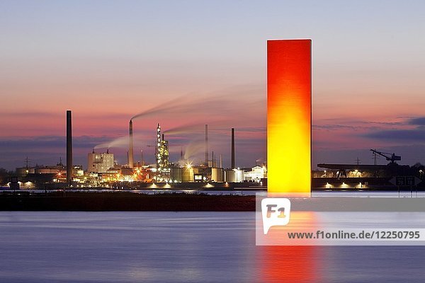 Illuminated sculpture Rheinorange in the sunset in front of industrial panorama  Rhine  Duisburg  Ruhr Area  North Rhine-Westphalia  Germany  Europe