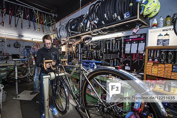 Mann repariert Fahrrad  Fahrradwerkstatt  Radcafe Schicke Mütze  Düsseldorf  Nordrhein-Westfalen  Deutschland  Europa