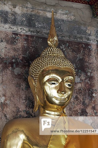 Head of a golden Buddha statue in meditation posture  on decorated pedestal  Phra Rabieng Kot  Wat Suhtat  royal temple  Phra Nakhon  Bangkok  Thailand  Asia