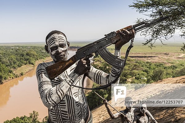 Warrior with rifle  Kalashnikov  AK47  Karo tribe  back Grandma River  Southern Nations Nationalities and Peoples' Region  Ethiopia  Africa