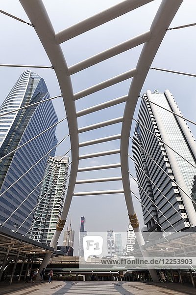 High-rise buildings in the business district Sathon and pedestrian bridge to BTS Skytrain station Chong Nonsi  Sathon  Bangkok  Thailand  Asia