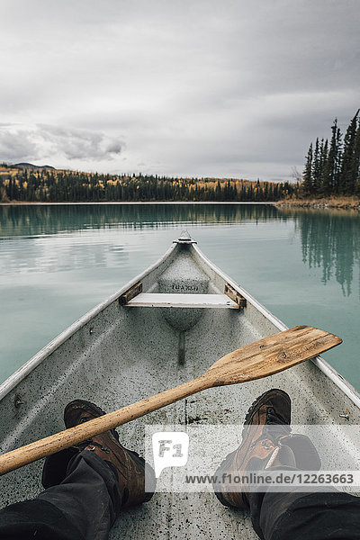 Canada  British Columbia  legs of a man in canoe on Boya Lake