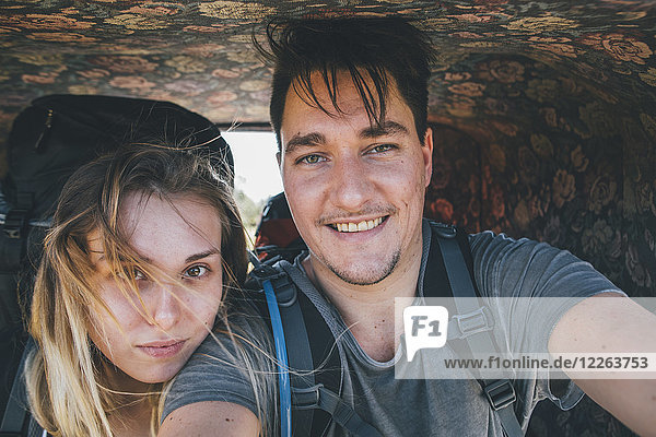 Junges Paar in einer Pferdekutsche mit einem Selfie