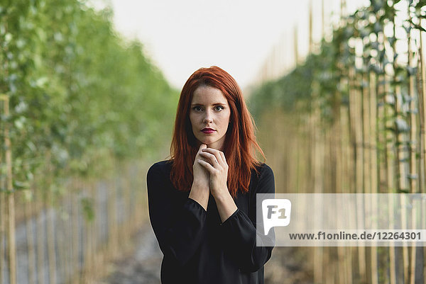 Portrait of redheaded young woman in nature
