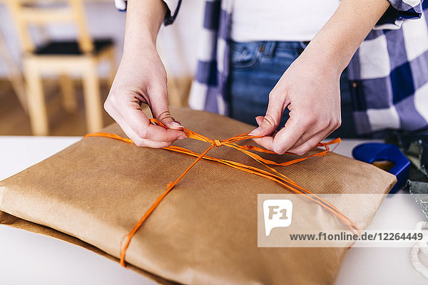 Close-up of woman wrapping a package