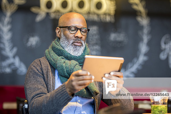 Portrait of man using tablet in a coffee shop