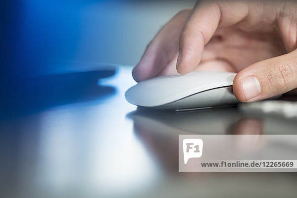 Man's hand using computer mouse