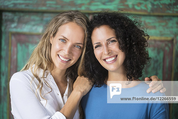 Portrait of two smiling women side by side