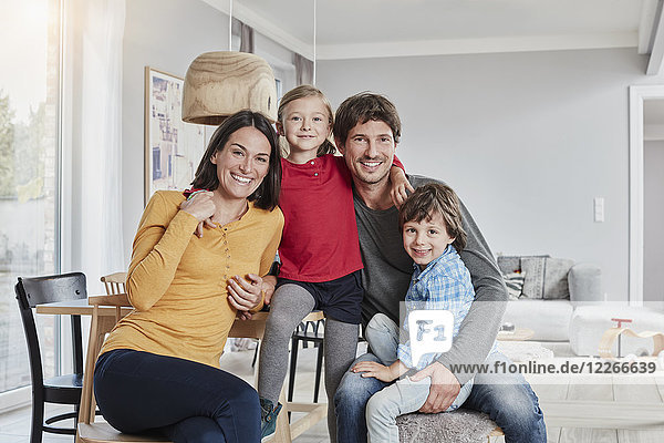 Portrait of happy family with two kids at home