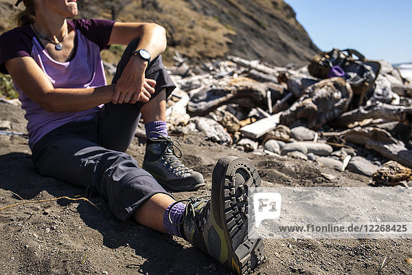 Female hiker resting on beach  Lost Coast Trail  Kings Range National Conservation Area  California  USA