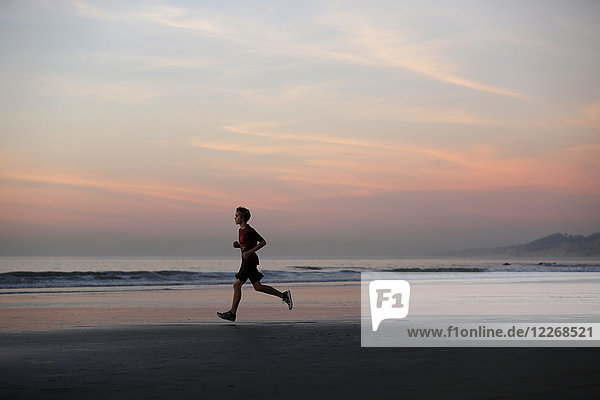 Runner at sunset on La Jolla Shores Beach  San Diego  California  USA