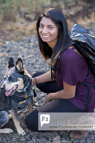 Smiling woman and her Blue Heeler dog at Mount Pisgah in Oregon  USA