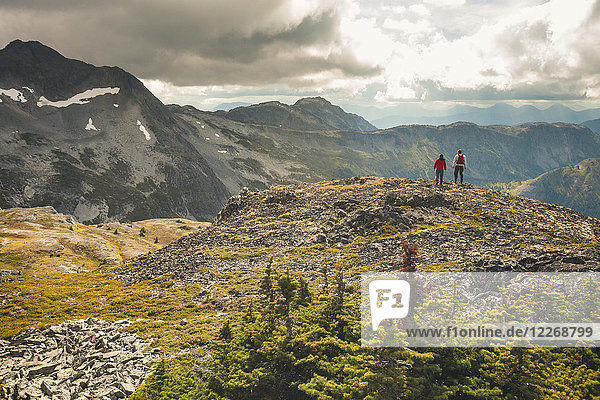 Father and son hiking on rocky ridge  Merritt  British Columbia  Canada