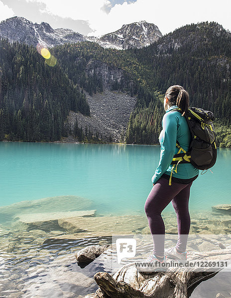 Female backpacker standing on shore of Middle Joffre Lake  Duffy Lake Provincial Park  Pembreton  British Columbia  Canada