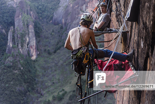 Rock climber securing portaledge  Liming  Yunnan Province  China