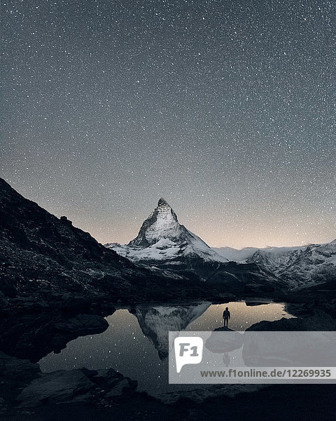 Matterhorn reflecting over Lake Riffelsee at night Zermatt Valais Switzerland