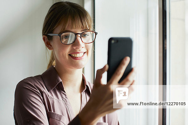 Woman looking at smartphone smiling