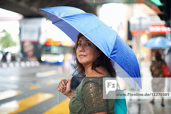 Tourist waiting to cross street  Kuala Lumpur  Malaysia