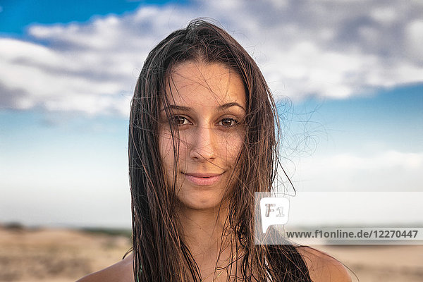 Portrait of teenage girl with long brown wet hair looking at camera smiling  Caucaia  Ceara  Brazil