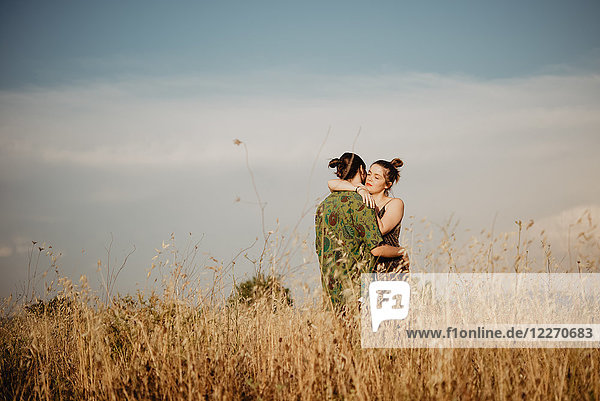 Couple on golden grass field  Arezzo  Tuscany  Italy