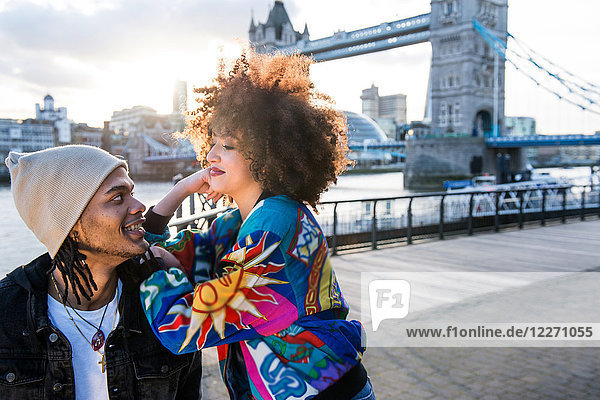 Portrait of young couple outdoors  face to face  Tower Bridge in background  London  England  UK
