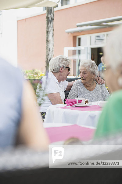 Ältere Frauen sitzen im Freien