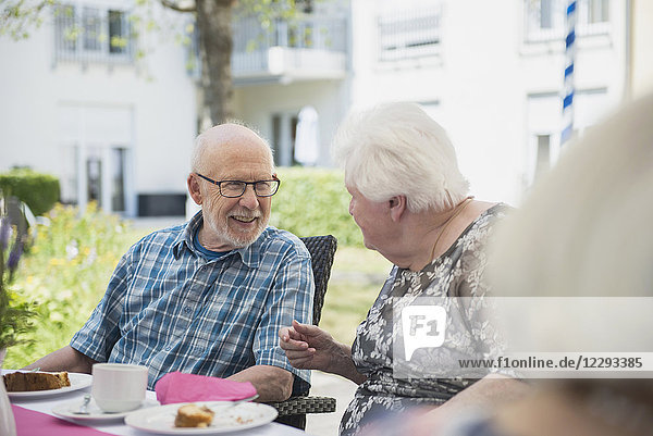 Senior people talking on breakfast table