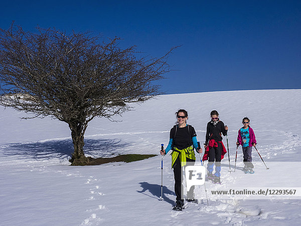 Mother and daughter on snowshoe tour at Mount Gorbea  Biscay  Basque Country  Spain
