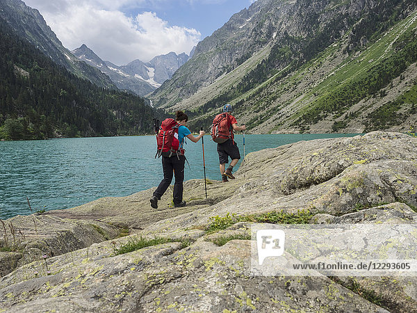Man and woman hiking in the High Pyrenees near Gaube Lake  Cauterets  France
