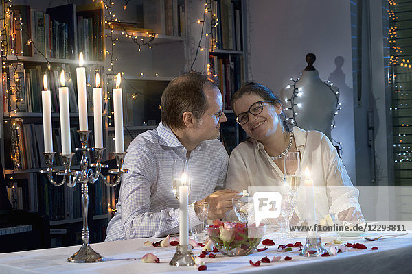 Romantic couple enjoying a candlelight dinner