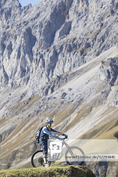 Mountain biker enjoying panoramic view on top of mountain
