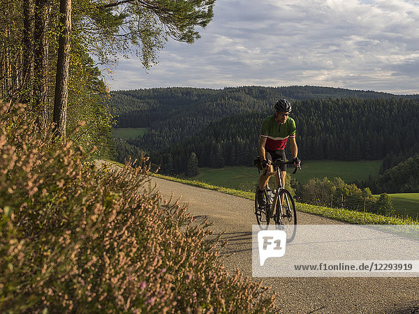 Man riding racing bicycle on cycling tour in the Middle Black Forest  Germany