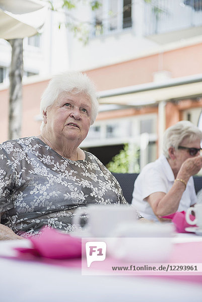 Senior woman sitting on table