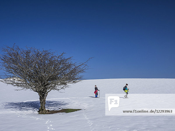 Mother and daughter on snowshoe tour at Mount Gorbea  Biscay  Basque Country  Spain