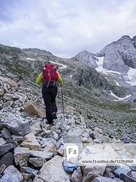 Woman hiking in the High Pyrenees ascending to mount Vignemale  Cauterets  France